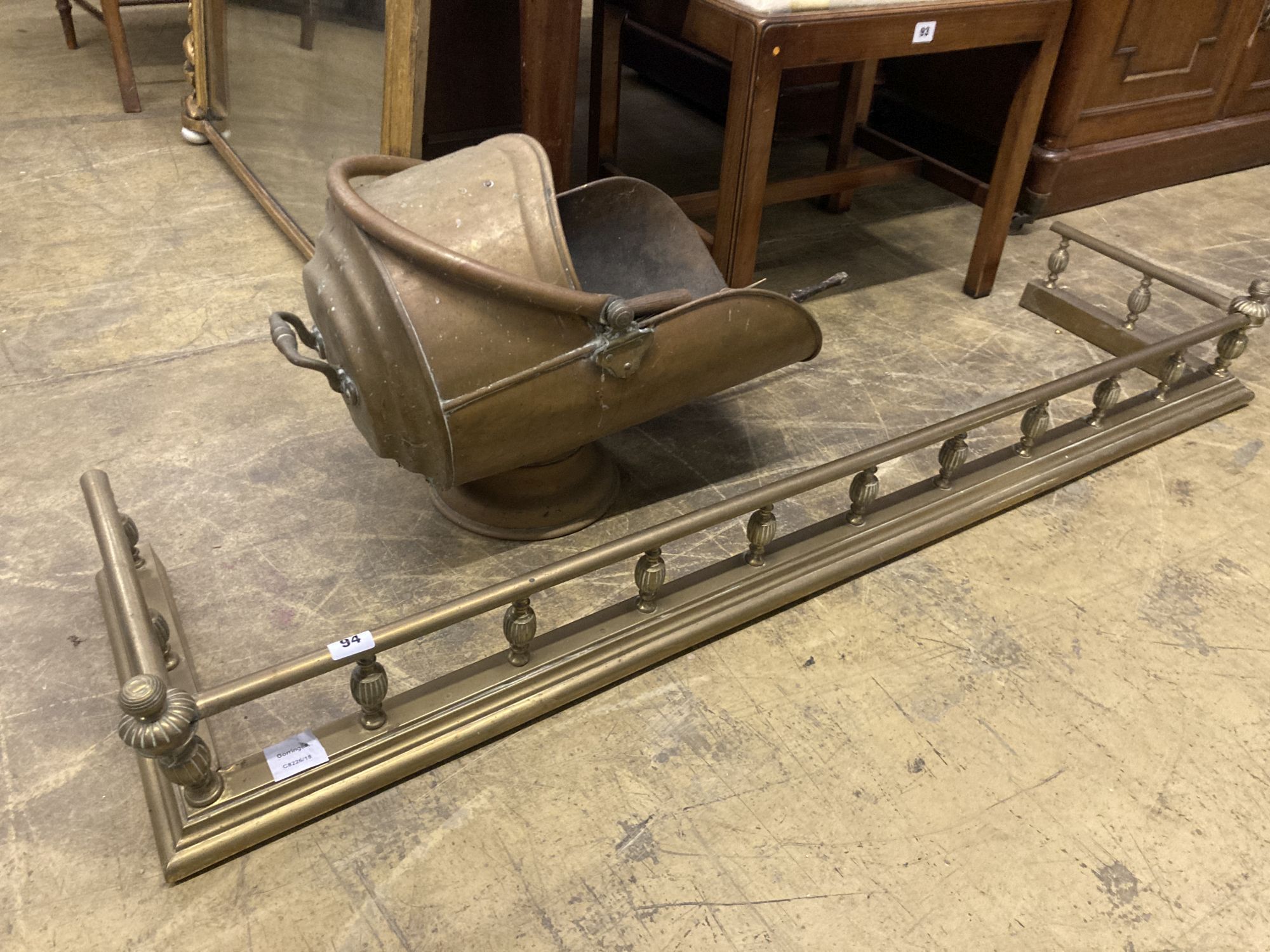 A Victorian brass kerb, length 140cm, together with a brass coal helmet and sundry brass fire implements